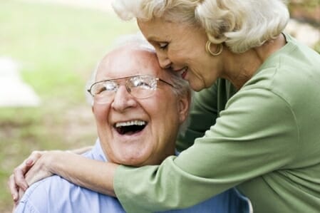 Happy elderly couple hugging each other