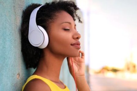 Woman happily listening to music on headphones